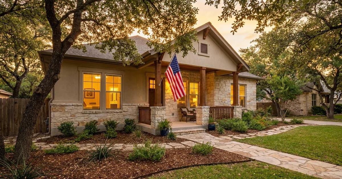 Welcoming San Antonio single-family home with a U.S. flag on the front porch at dusk