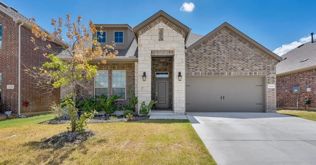 Tree-lined Plano single-family residential street with classic Collin County brick homes in warm afternoon light — the Plano ISD attendance-zone rental stock that anchors corporate-relocation demand from Legacy West and the Plano Toyota North America campus