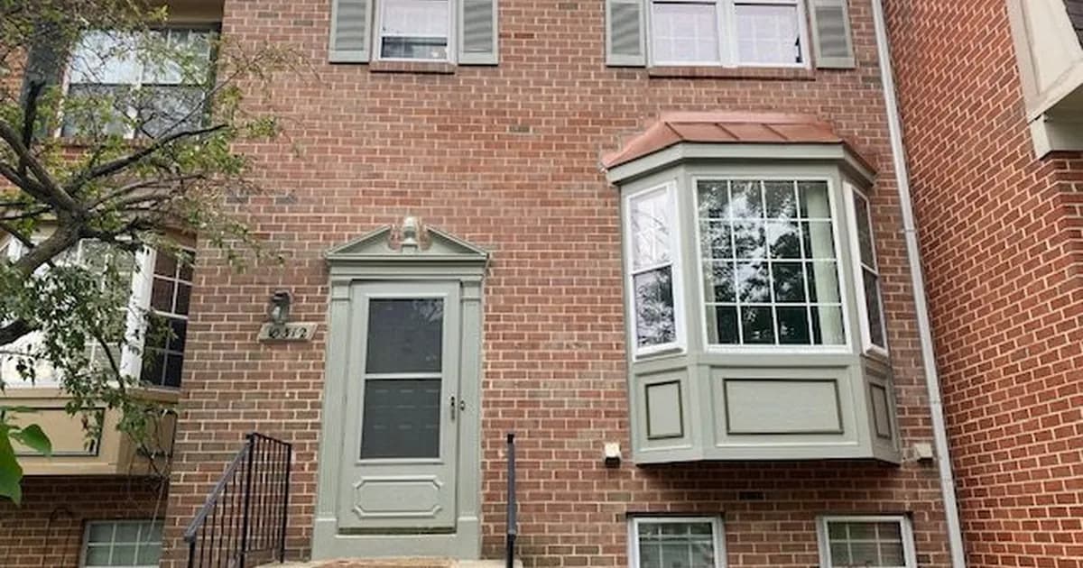 Single-family rental home on a historic Annapolis Maryland street in warm daylight — the Anne Arundel County Public Schools attendance-zone stock that anchors Naval Academy and state-government rental demand