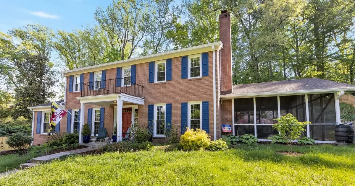Stately colonial single-family rental homes on a tree-lined Chevy Chase street in warm daylight — the Montgomery County Bethesda-Chevy Chase MCPS-cluster stock that anchors DC-adjacent, embassy-row rental demand