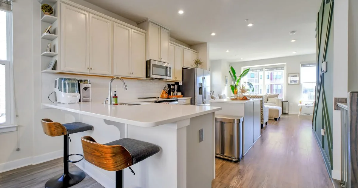 Modest brick single-family rental homes on a District Heights street in warm daylight — the inside-the-Beltway Prince George’s County PGCPS-zoned stock that anchors Suitland and DC-corridor rental demand