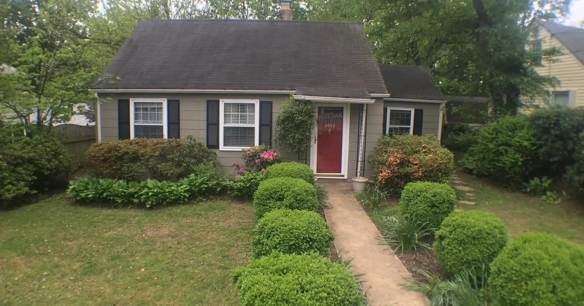 Single-family rental home on a wooded Greenbelt Maryland street in warm daylight — the Prince George’s County stock near NASA Goddard and the Greenbelt Metro terminus that anchors federal-scientist rental demand