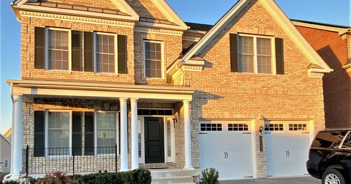 Single-family rental home on a Laurel Maryland street in warm daylight — the Prince George’s County stock at the Baltimore–Washington corridor junction that anchors Johns Hopkins APL and Fort Meade rental demand