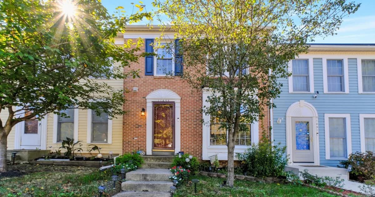 Single-family rental home on a tree-lined Severna Park Maryland street in warm daylight — the affluent Baltimore & Annapolis corridor, top-rated Anne Arundel County Public Schools stock that anchors relocating-professional rental demand