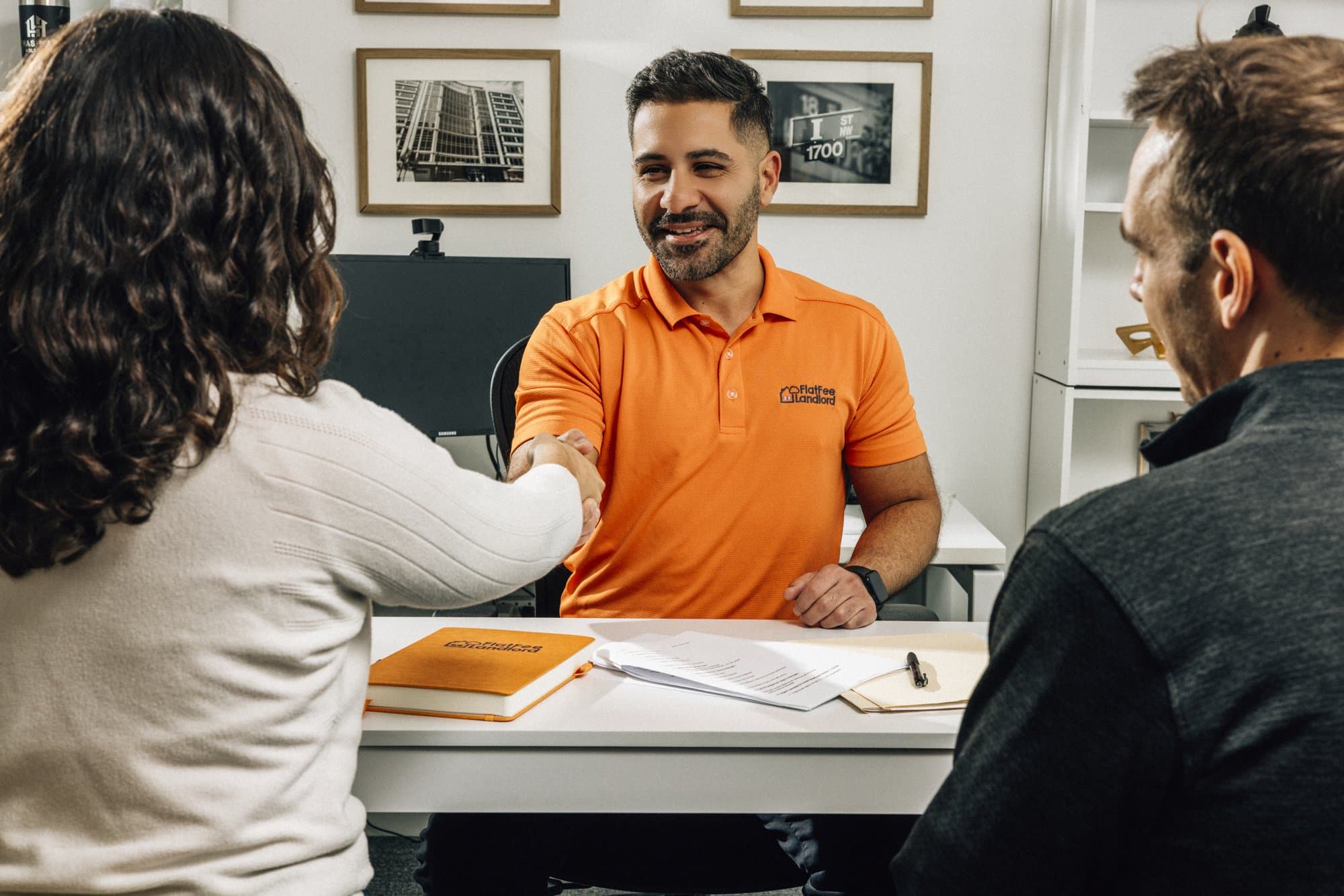 Flat Fee Landlord team member shaking hands with landlord clients after signing