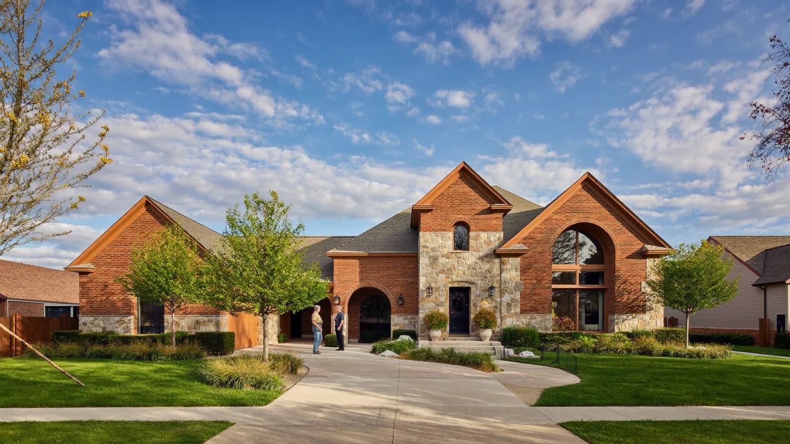 Fort Worth landlord shaking hands with a property manager outside a ranch-style single-family rental home