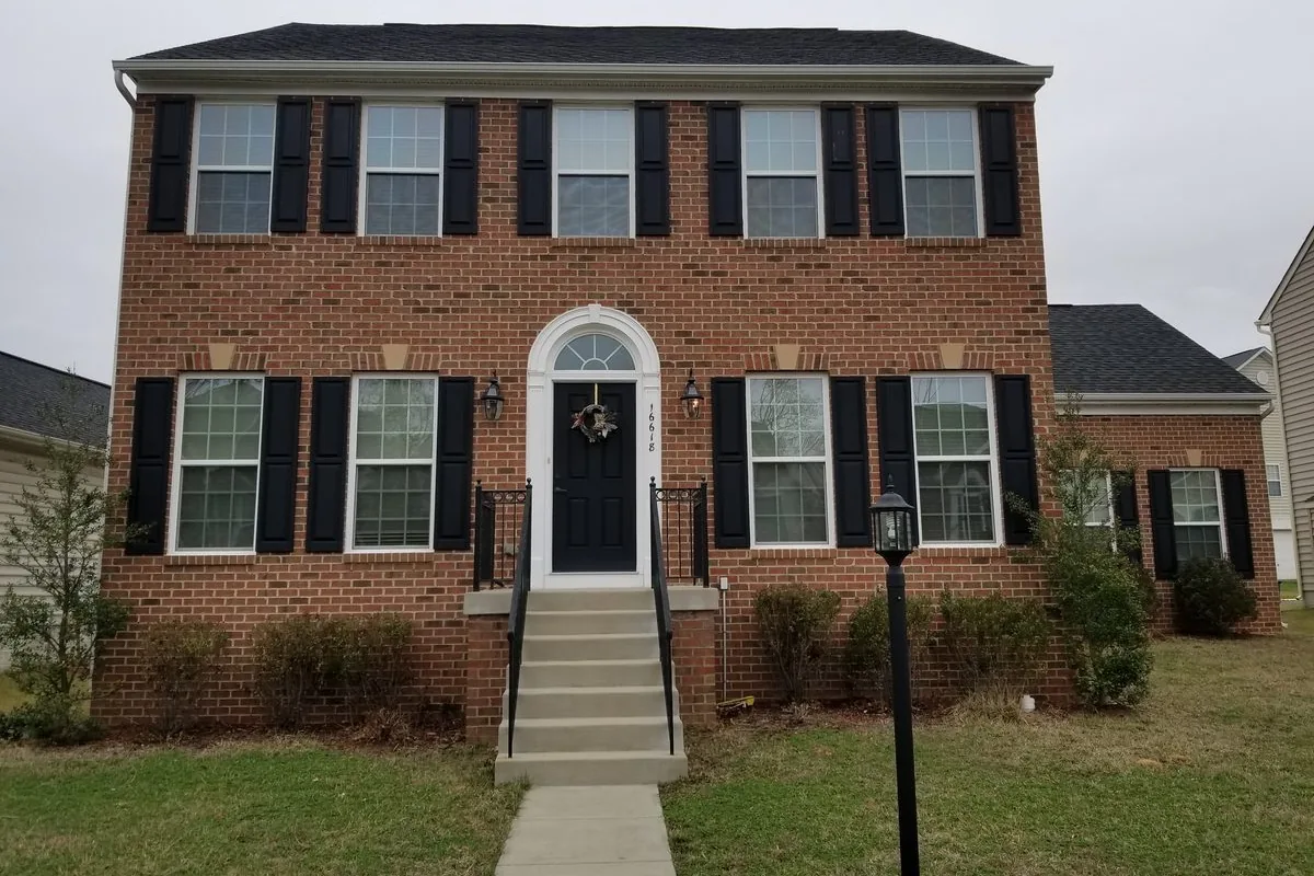 Brick colonial single-family rental home in a Northern Virginia suburb — representative of the Fairfax, Loudoun, and Prince William County properties Flat Fee Landlord places tenants in