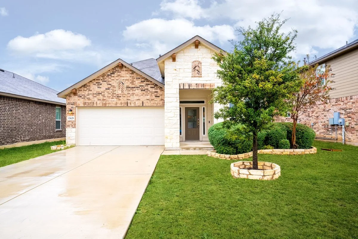 Two-story stone-and-stucco single-family rental home in a San Antonio suburb — representative of the properties Flat Fee Landlord places tenants in across Bexar County